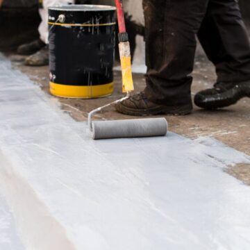 Paint roller, insulating the roof of the building