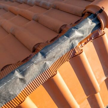 Closeup of yellow clay roofing ridge capping on top of resident