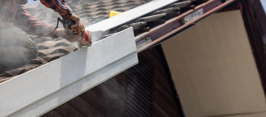 Handyman replace roof eaves with artificial wood.